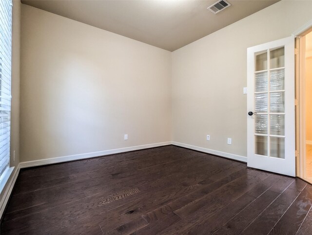 spare room with dark wood-type flooring