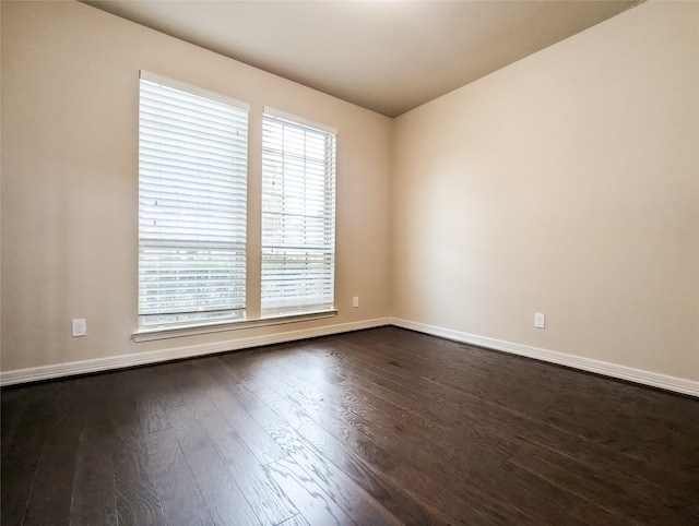 empty room featuring dark hardwood / wood-style flooring