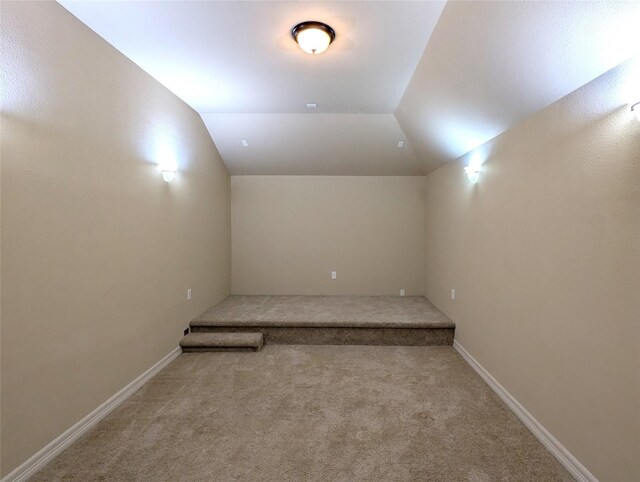 bonus room with lofted ceiling and carpet floors