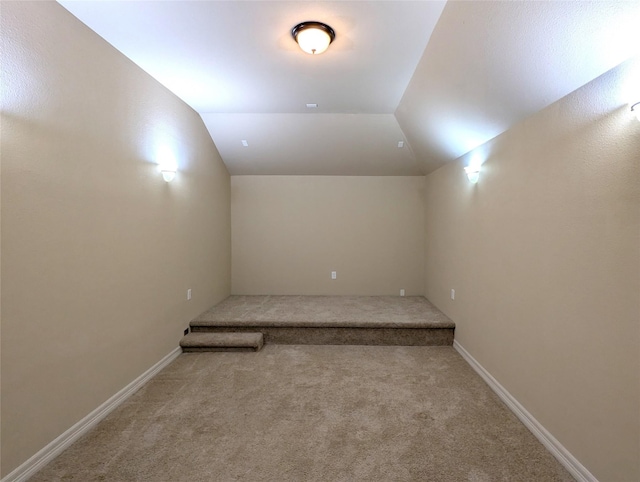 interior space with lofted ceiling, carpet, and baseboards