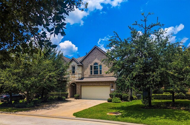 view of front of house with a garage and a front lawn