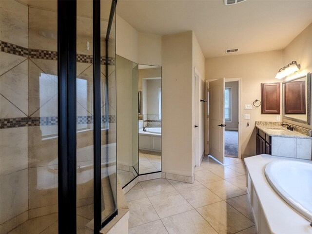 bathroom with vanity, tile patterned floors, and plus walk in shower