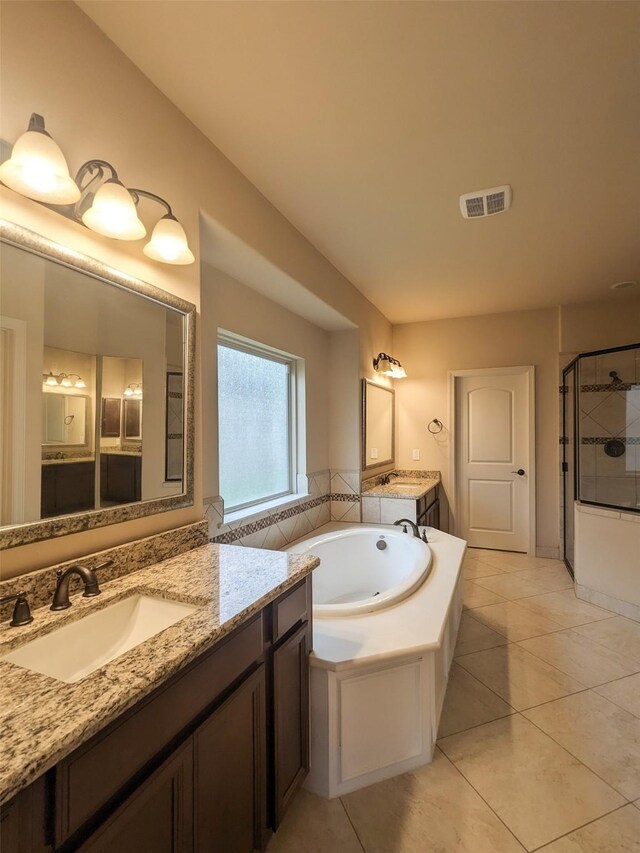 bathroom featuring tile patterned floors, vanity, and separate shower and tub