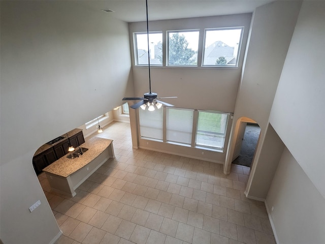 unfurnished living room featuring ceiling fan