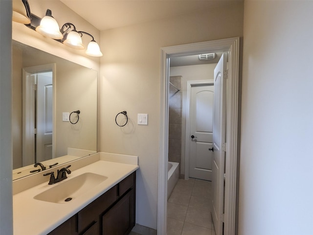 bathroom with tile patterned flooring, vanity, and a washtub