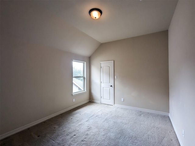 bonus room featuring light carpet, vaulted ceiling, and baseboards