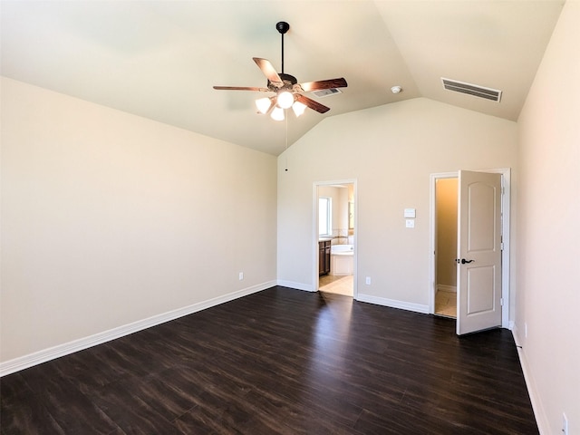 unfurnished bedroom with lofted ceiling, dark hardwood / wood-style floors, ceiling fan, and ensuite bathroom