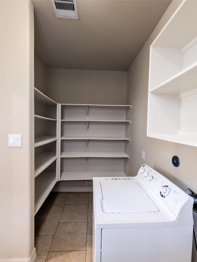 clothes washing area featuring washer / clothes dryer and light tile patterned floors