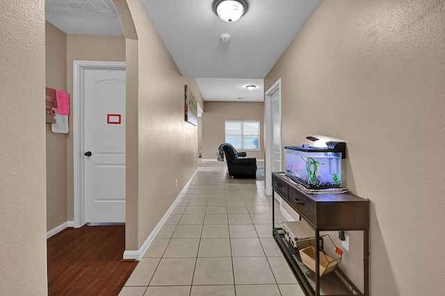 corridor with light tile patterned floors