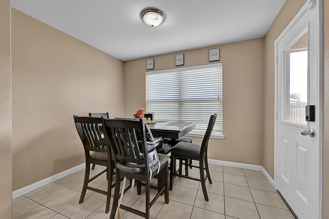 tiled dining room with a healthy amount of sunlight