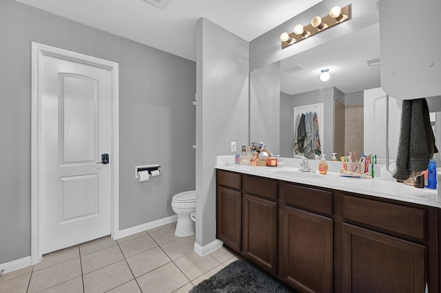 bathroom featuring vanity, tile patterned floors, and toilet