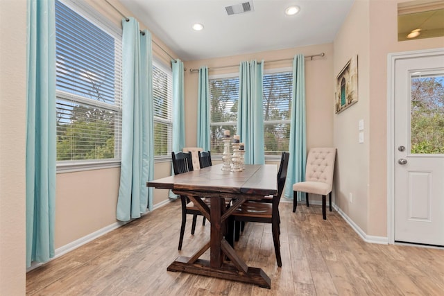 dining area featuring a wealth of natural light and light hardwood / wood-style flooring