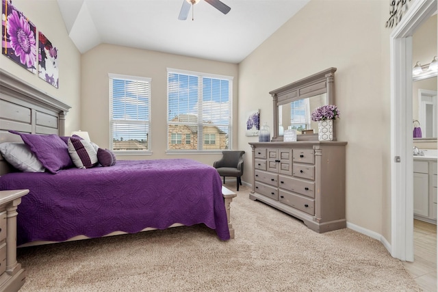 carpeted bedroom featuring vaulted ceiling, sink, and ceiling fan