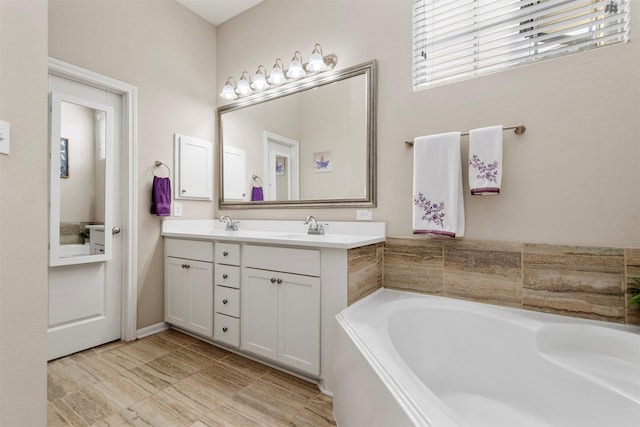 bathroom with vanity and a bathtub