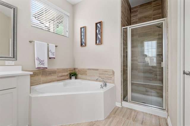 bathroom with vanity and separate shower and tub