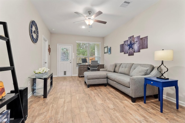 living room with ceiling fan and light hardwood / wood-style flooring