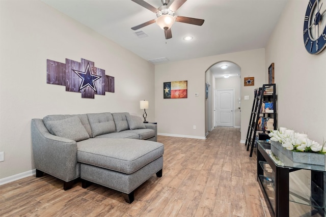 living room with wood-type flooring and ceiling fan