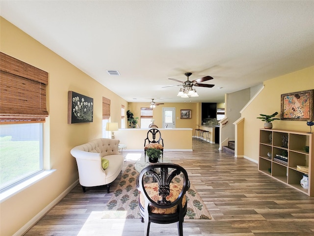 living room featuring ceiling fan and wood-type flooring