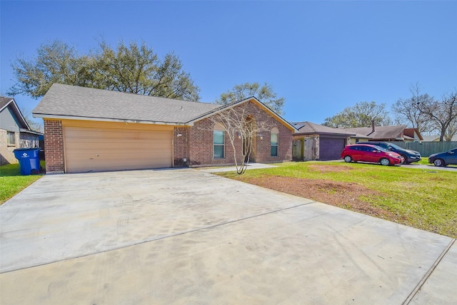 ranch-style home with a front lawn, a garage, brick siding, and driveway