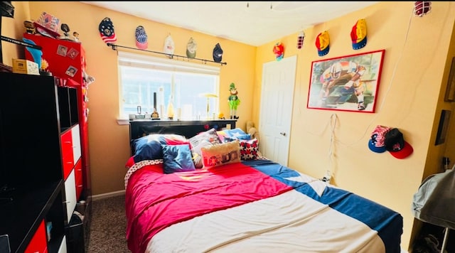 bedroom featuring dark carpet