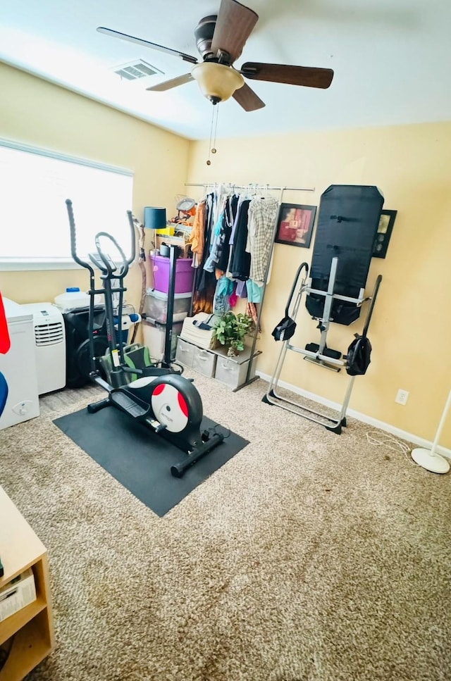 exercise area featuring carpet flooring and ceiling fan