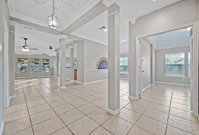 foyer with crown molding, a wealth of natural light, light tile patterned floors, and ornate columns