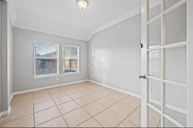 spare room with ornamental molding and light tile patterned floors