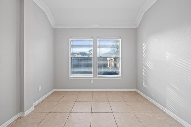 spare room with ornamental molding and light tile patterned floors