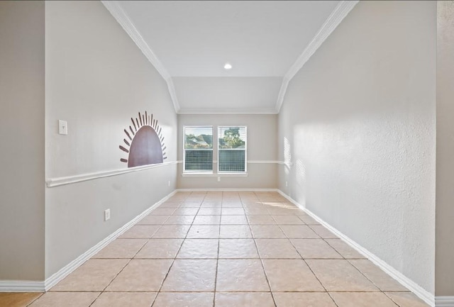 tiled empty room featuring crown molding