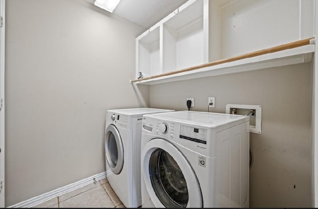 washroom featuring separate washer and dryer and light tile patterned floors