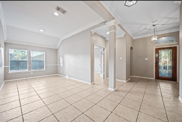 foyer entrance featuring crown molding, light tile patterned flooring, vaulted ceiling, and ornate columns