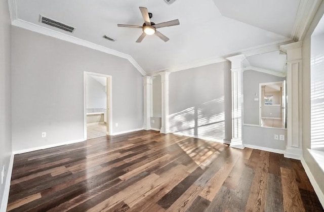 unfurnished living room featuring ceiling fan, dark hardwood / wood-style floors, ornamental molding, vaulted ceiling, and ornate columns