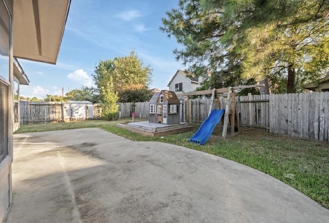 view of jungle gym featuring a patio area and a lawn