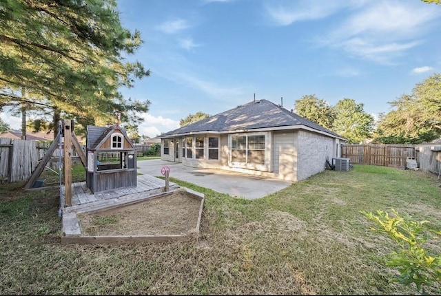 back of property featuring cooling unit, a patio area, and a lawn