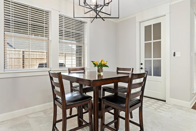 dining area with a notable chandelier and ornamental molding