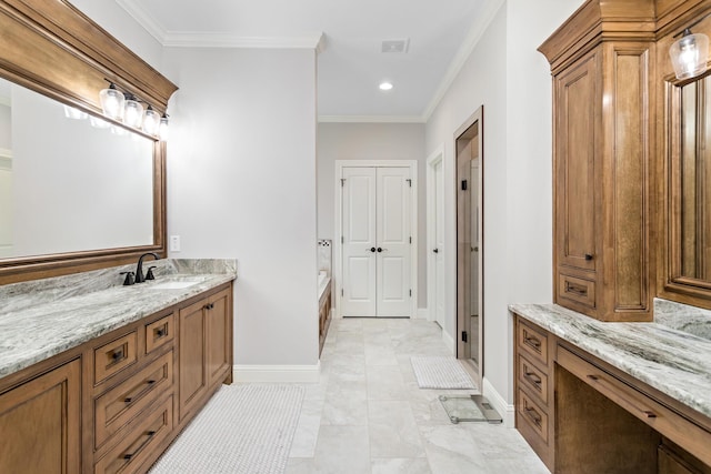 bathroom with crown molding, vanity, and a bath