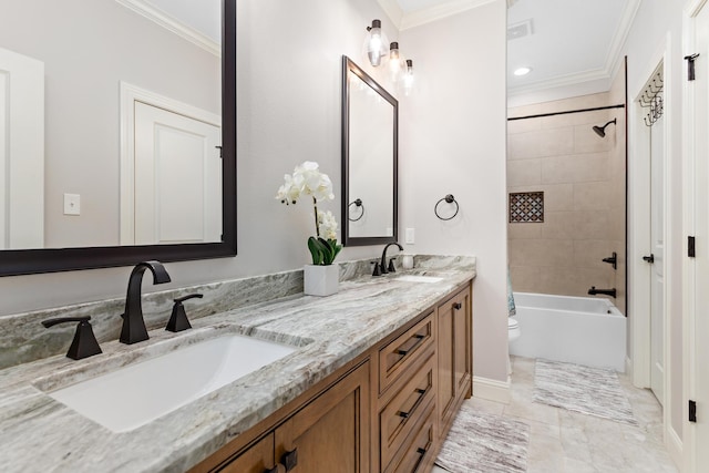 full bathroom featuring ornamental molding, toilet, tiled shower / bath combo, and vanity