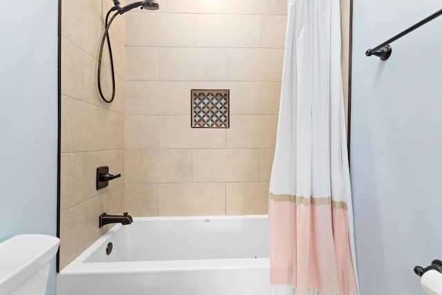 bathroom featuring shower / tub combo with curtain and toilet