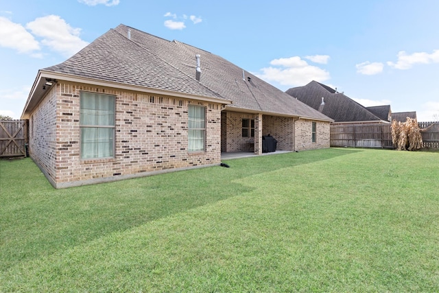 rear view of house with a yard