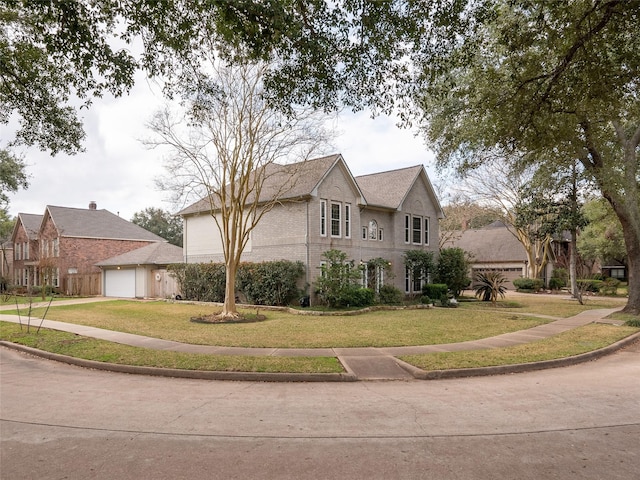 view of front of house featuring a garage and a front yard