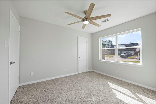 unfurnished bedroom with ceiling fan, carpet, visible vents, and baseboards