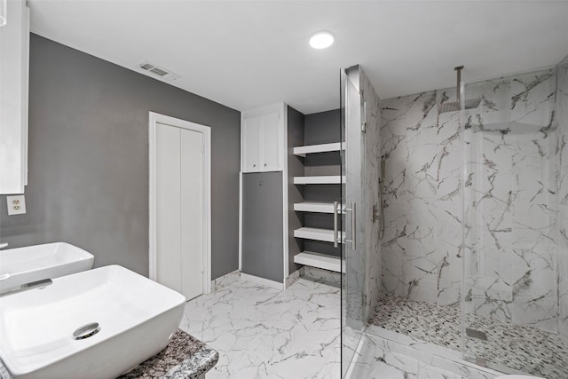 bathroom featuring a sink, marble finish floor, a closet, and a marble finish shower