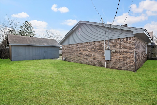 exterior space with a yard and brick siding