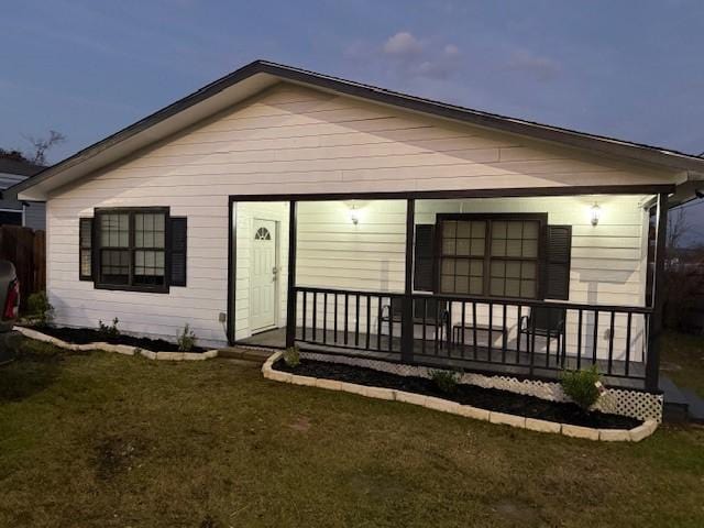 rear view of house with a lawn