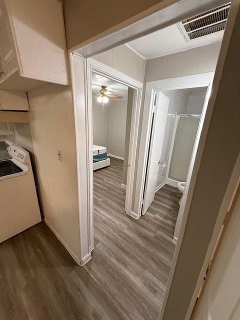 hallway with washer / dryer and dark wood-type flooring