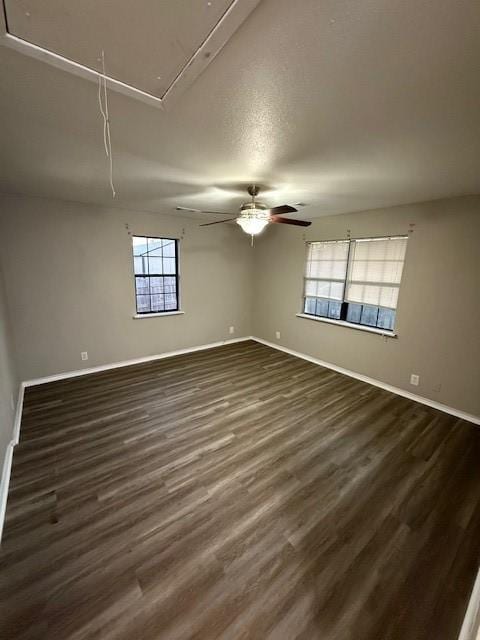 empty room featuring dark hardwood / wood-style flooring and ceiling fan