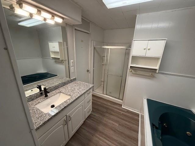 bathroom featuring vanity, hardwood / wood-style floors, and walk in shower