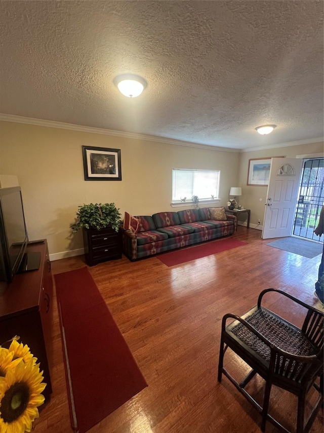 living room featuring dark wood-type flooring, a wealth of natural light, and ornamental molding