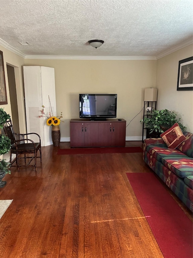 living room with ornamental molding, dark hardwood / wood-style floors, and a textured ceiling