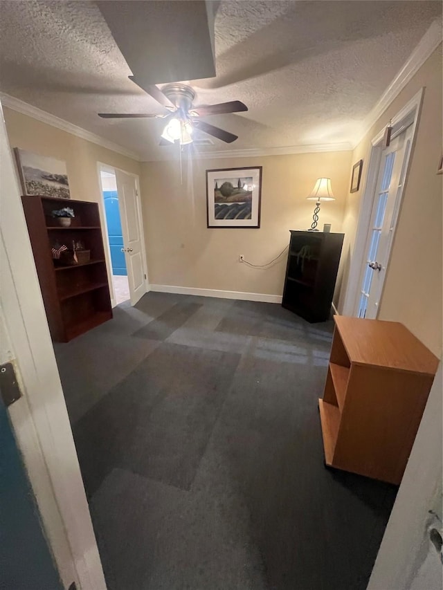 interior space with ceiling fan, ornamental molding, and a textured ceiling